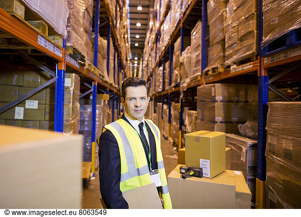 Businessman standing in warehouse