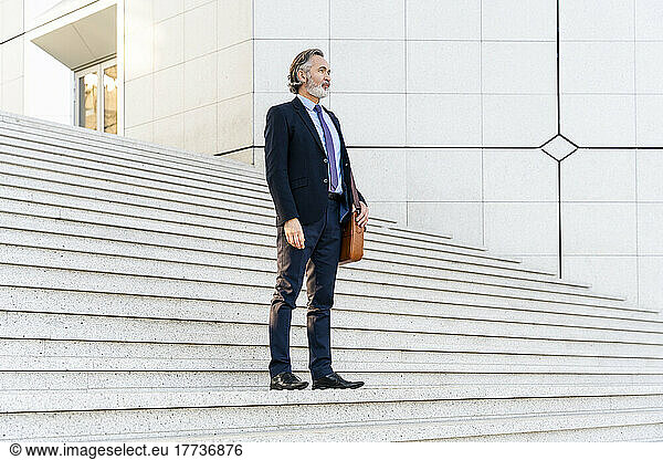 Businessman standing on staircase