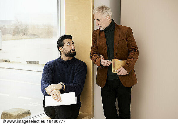 Businessman talking with colleague in office