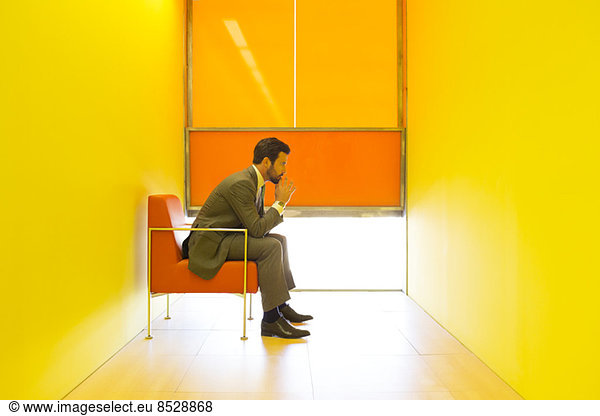 Businessman thinking in bright office
