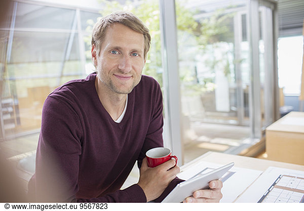 Businessman using digital tablet at office desk