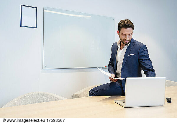 Businessman using laptop and working on laptop in meeting room