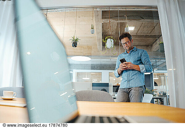 Businessman using mobile phone at office