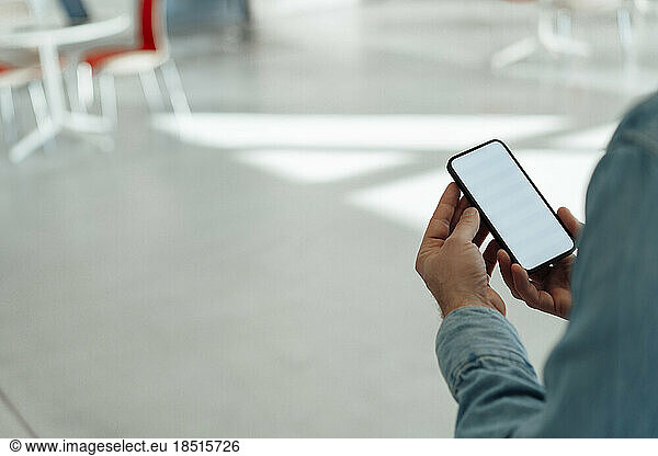 Businessman using mobile phone in office