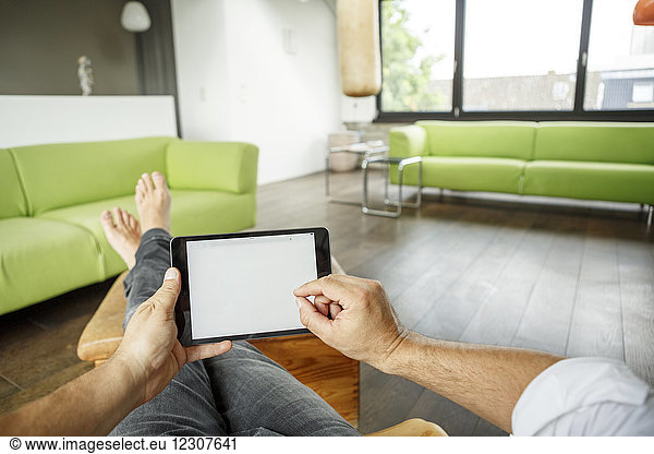 Businessman using tablet at home