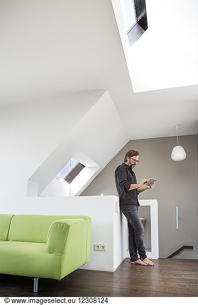 Businessman using tablet at home