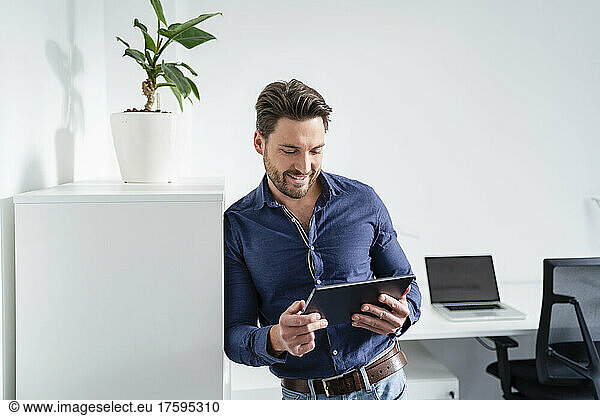 Businessman using tablet PC in office
