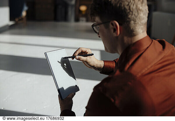 Businessman using tablet PC with digitized pen in office