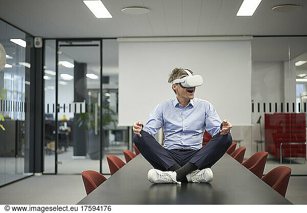 Businessman wearing VR glasses in meeting room at modern office