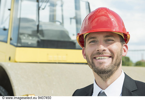 Businessman with hard hat on construction site