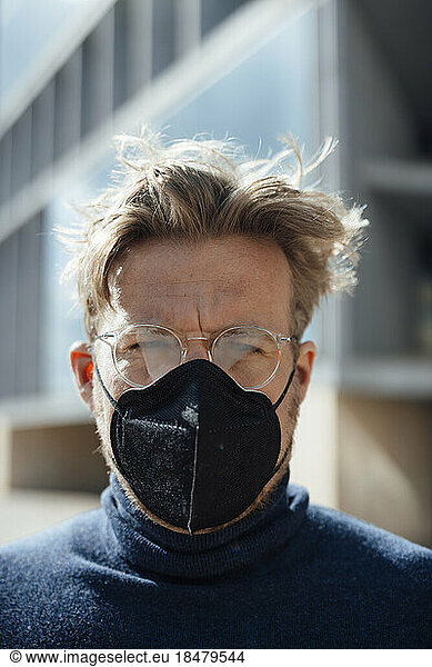 Businessman with protective face mask wearing eyeglasses