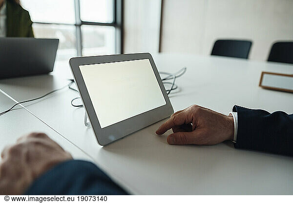 Businessman with tablet PC at desk