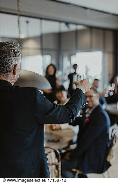 Businessman with wineglass during office party