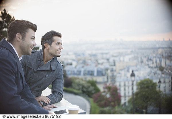 Businessmen overlooking cityscape  Paris  France
