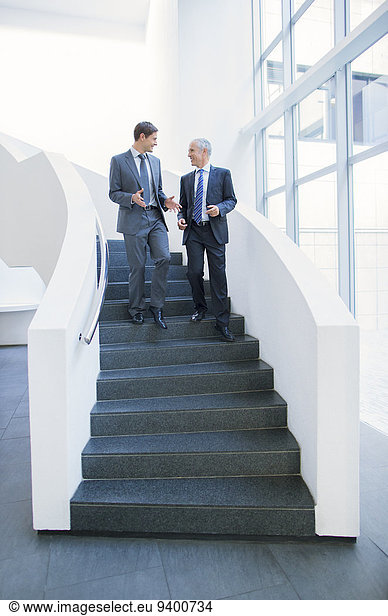 Businessmen talking on stairs