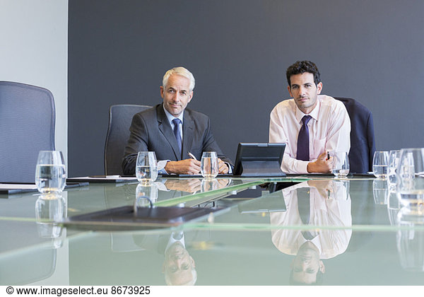 Businessmen using digital tablet in meeting