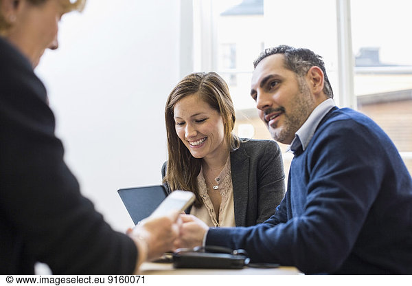Businesspeople in meeting at office desk