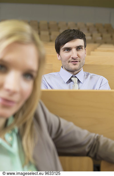 Businesspeople sitting in auditorium
