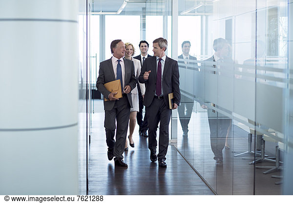 Businesspeople walking in hallway