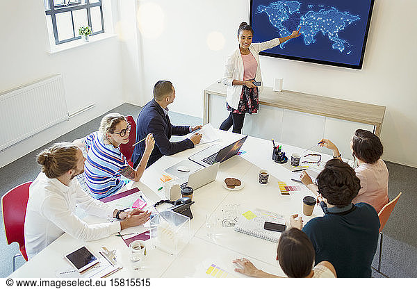 Businesswoman at screen in conference room meeting