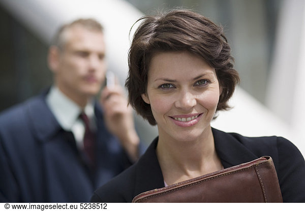 Businesswoman carrying leather folder