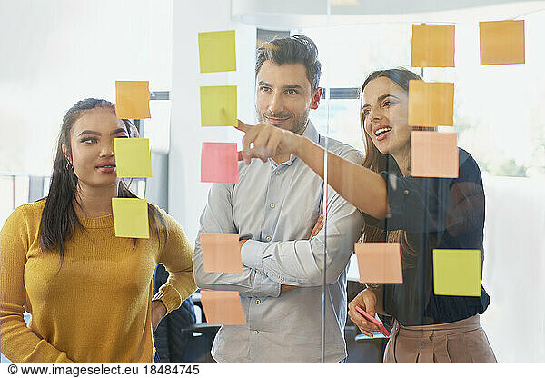 Businesswoman conducting brainstorming session with colleagues at office
