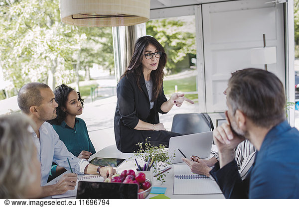 Businesswoman discussing strategy with colleagues in portable office truck