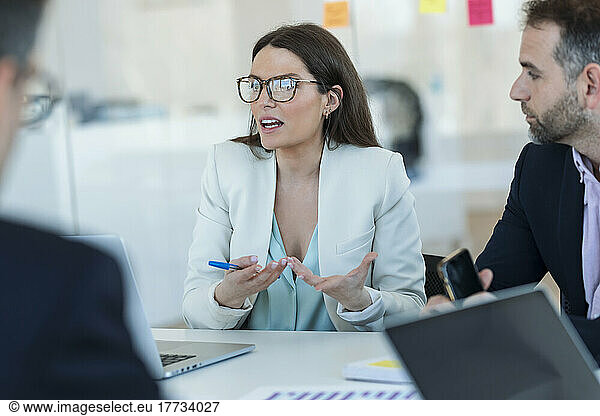 Businesswoman explaining colleagues in meeting at office