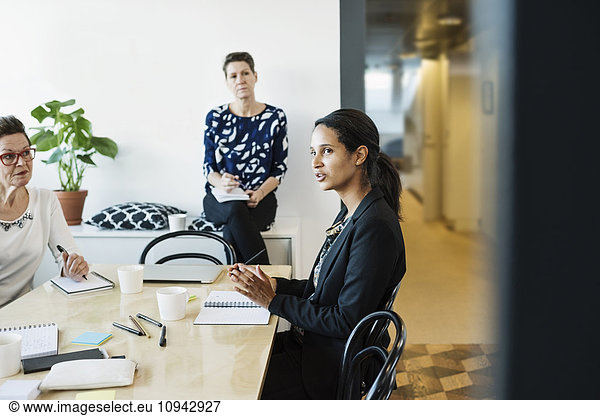 Businesswoman explaining during meeting in board room