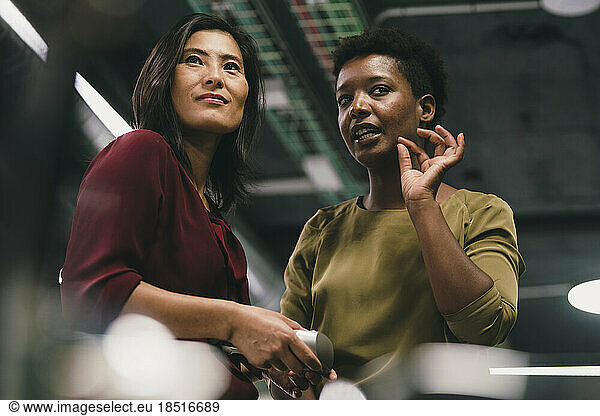 Businesswoman explaining to colleague in office