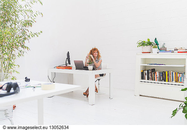 Businesswoman gazing from office desk
