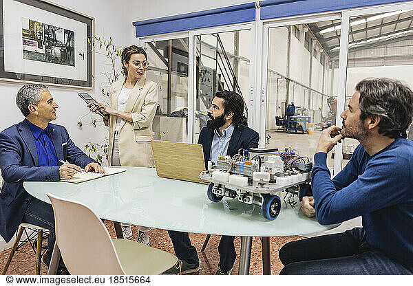 Businesswoman having meeting with colleagues in industry