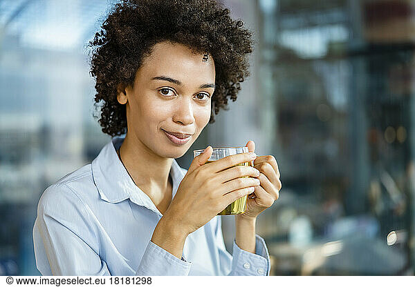Businesswoman holding tea cup at office