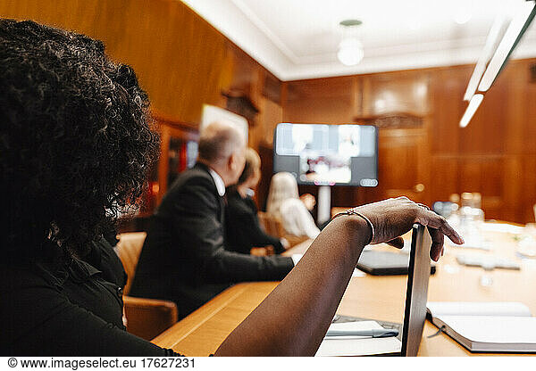 Businesswoman in video conference meeting with colleagues
