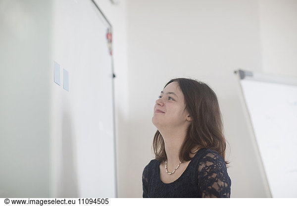 Businesswoman looking adhesive notes in office