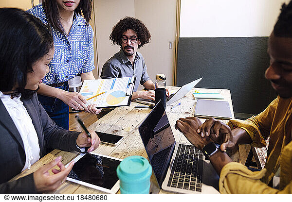 Businesswoman planning strategy with colleagues in meeting at office
