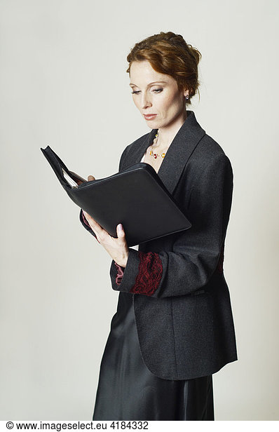Businesswoman reading or writing in her documents