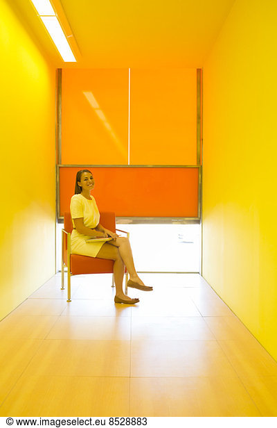 Businesswoman sitting in bright office