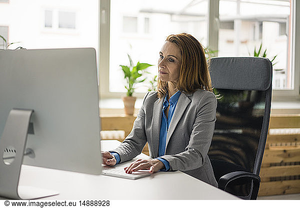 Businesswoman sitting in office  working on PC