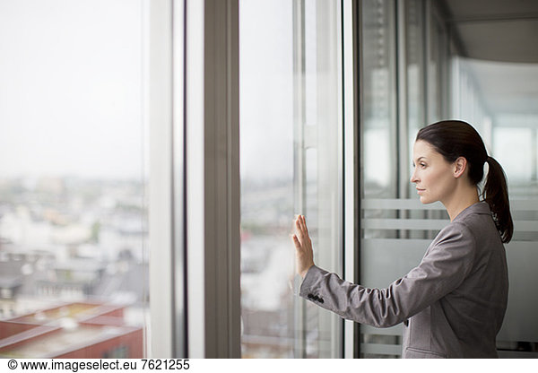 Businesswoman standing at office window