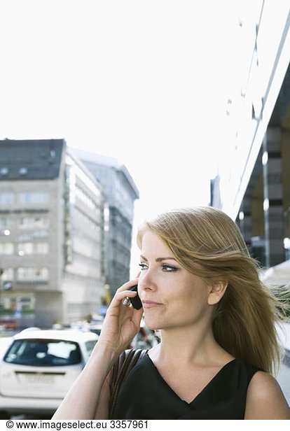 Businesswoman talking in cellphone outdoors