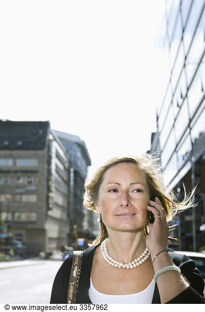 Businesswoman talking in cellphone outdoors