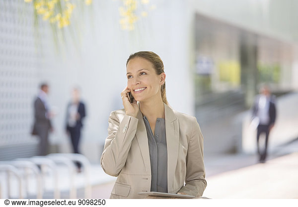 Businesswoman talking on cell phone outdoors