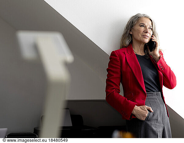 Businesswoman talking on smart phone at office