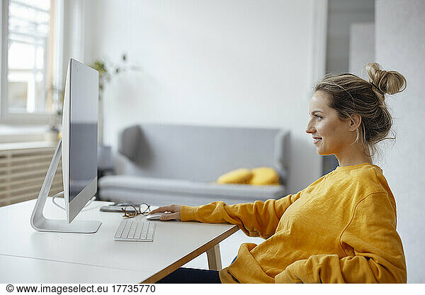 Businesswoman using desktop PC at home