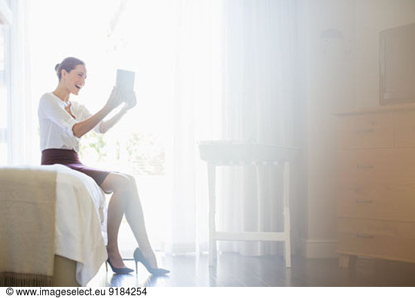 Businesswoman using digital tablet in hotel room