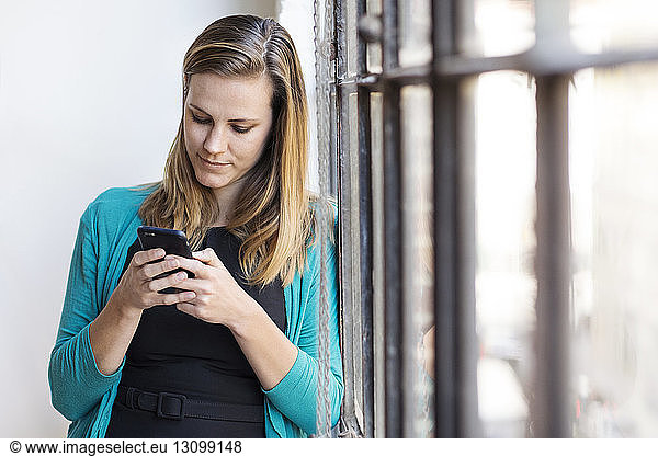 Businesswoman using mobile phone at office