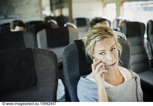 Businesswoman using smart phone in train