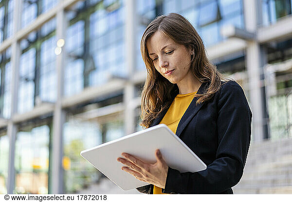 Businesswoman using tablet PC outdoors