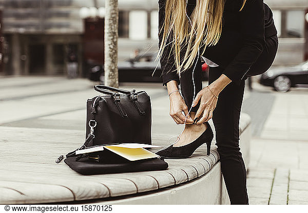 Businesswoman wearing high heels while standing outdoors